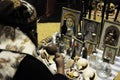 mannequin in the museum of tucume of a seated sorcerer shaman making tributes and offerings with religious pictures peru