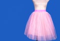 Mannequin in pink princess skirt on blue background Royalty Free Stock Photo