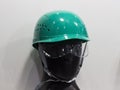 A mannequin with Safety helmets on a shelf ; Working Hard Hat