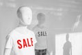 Mannequin with Sale t-shirts in fashion clothes store shop window Royalty Free Stock Photo