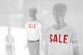 Mannequin with Sale t-shirts in fashion clothes store shop window Royalty Free Stock Photo