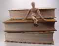 Mannequin Sitting on Books Royalty Free Stock Photo