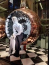 Mannequin sitting inside huge Christmas bauble at the Prada store in Athens