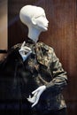 Mannequin standing in store window display of womens casual clothing shop