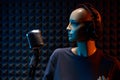 Mannequin with studio retro condenser microphone and professional headphones