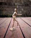 Articulating Artist Wood Mannequin on Wooden Deck Royalty Free Stock Photo