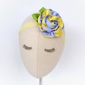 A mannequin wearing flower headband made out of grosgrain ribbon