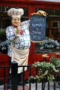 Mannequin welcoming cook outside an italian restaurant.