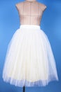 Mannequin in white princess skirt on blue background Royalty Free Stock Photo