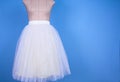 Mannequin in white princess skirt on blue background Royalty Free Stock Photo