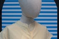 Mannequin with white and yellow vertical striped shirt