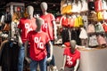 Mannequins dressed in red t-shirts with percentage sign in the shopping mall. Season of discounts and sales