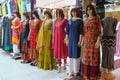 Mannequins dressed in trendy national Central and South Asia fashion casual clothes displayed in front of retail shop