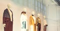 Mannequins in fashion shop display window inside of mall. Female casual style. Side view. Wide banner. Selective focus. Copy space