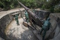 Mannequins of soldiers manipulating a large cannon at Cannon Fort in Cat Ba, Vietnam