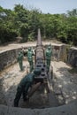 Mannequins of soldiers manipulating a large cannon at Cannon Fort in Cat Ba, Vietnam