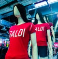 Mannequins in stores that wear in a beautiful shirt with the word sales.