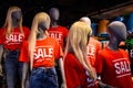 Mannequins in a window of a clothing store in T-Shirts With Signs Advertising Sale Royalty Free Stock Photo