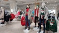 Mannequins in winter jackets, sweatshirts with Christmas print. Dummy displaying fashionable jackets and ugly christmas sweaters i