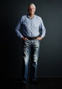 Manners maketh man. Studio portrait of a handsome mature man posing against a dark background. Royalty Free Stock Photo