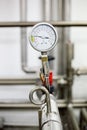 Manometer on pipe in milk production machine