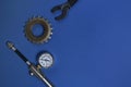 Manometer, sprocket and wrench on background, flat lay with space for text. Bicycle tools