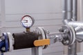 Manometer and thermometer for measuring the temperature and pressure of water in the plumbing system at a gas boiler room