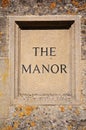 The Manor sign carved in Cotswold stone.