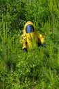 Mans with briefcase in protective hazmat suit