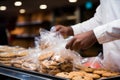 Mans close up action securing cookies inside a plastic bag during grocery shopping