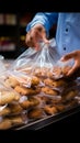 Mans close up action securing cookies inside a plastic bag during grocery shopping