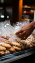 Mans close up action securing cookies inside a plastic bag during grocery shopping