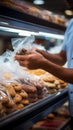 Mans close up action securing cookies inside a plastic bag during grocery shopping