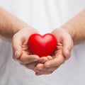 Mans cupped hands showing red heart