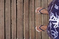 Mans feet in flip flops on wooden boardwalk. Top view. Flat lay. Empty space, for text Royalty Free Stock Photo