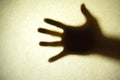 Shadow hands of the Man behind frosted glass. Royalty Free Stock Photo