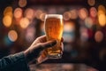 a mans hand clutches a satisfying glass of beer in a cozy pub. Royalty Free Stock Photo