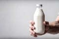 Mans Hand Holds Bottle Of Milk Against White Background. Generative AI Royalty Free Stock Photo