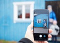 Mans hand making photo of a little girl and woman with a mobile phone. Selective focus on a mobile phone Royalty Free Stock Photo