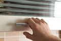 Mans hand open the kitchen cupboard doors, close up Royalty Free Stock Photo