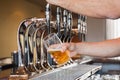 Mans hand pouring beer Royalty Free Stock Photo
