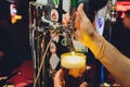Mans hand pouring pint of beer behind the bar. Royalty Free Stock Photo