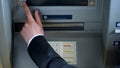 Mans hand pressing button on display screen of ATM machine, bank account access Royalty Free Stock Photo