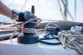 Mans hand pulling winch rope on sailing boat Royalty Free Stock Photo