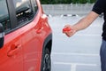 A mans hand using a remote control key to open a car parked in a parking lot. Remote control and vehicle protection Royalty Free Stock Photo