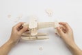 Mans hands assembling wooden hydroplane toy Royalty Free Stock Photo