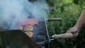 Mans hands prepring food on grill