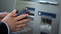 Mans hands putting euros in wallet, cash withdrawn from ATM, travelling abroad