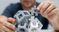 Mans hands putting the final piece into a complex geometric puzzle Royalty Free Stock Photo