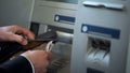 Mans hands putting Japanese Yen in wallet, cash withdrawn from ATM, travelling